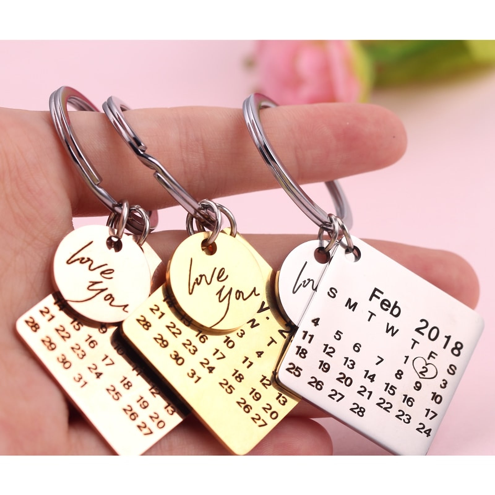 Engraved calendar keychains marking a date, with love-you charms