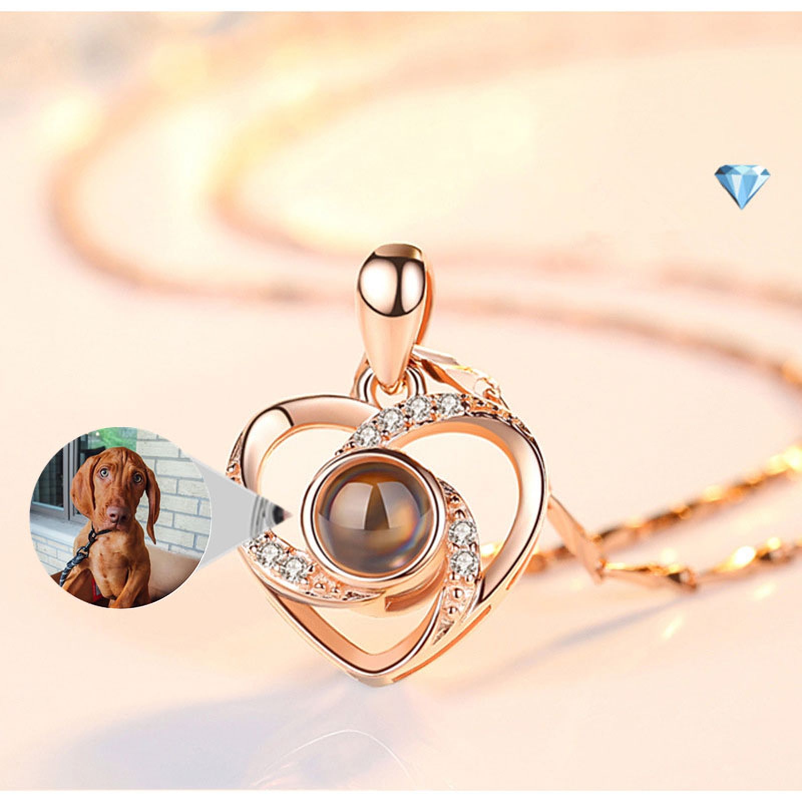 A rose-gold heart pendant with a tiny lens; the bubble shows the dog photo you see through it